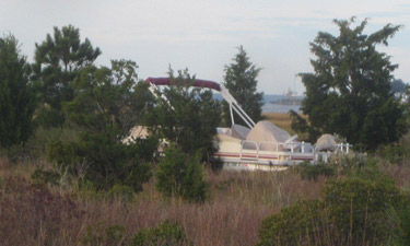 This boat was stranded aground more than 100 yards inland from the water in the marsh at Delaware Seashore State Park. This boat was stranded aground more than 100 yards inland from the water in the marsh at Delaware Seashore State Park.