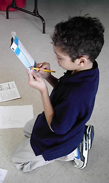A Wise Kids participant practices reading food labels. A Wise Kids participant practices reading food labels.