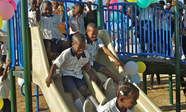 Haitian schoolchildren show the power of play on their donated playground from Kids Around the World. Haitian schoolchildren show the power of play on their donated playground from Kids Around the World.