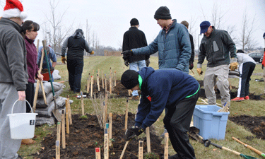 Jacob Schaffner (center, standing) directs his team of helpers during the December 2014 planting of monarch waystation No. 9712 at NRPA headquarters in Ashburn, Virginia.  Jacob Schaffner (center, standing) directs his team of helpers during the December 2014 planting of monarch waystation No. 9712 at NRPA headquarters in Ashburn, Virginia.
