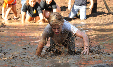 Kids indulge their natural attraction to messy fun during a Mud U event at Lake McMurtry in Stillwater, Oklahoma. Kids indulge their natural attraction to messy fun during a Mud U event at Lake McMurtry in Stillwater, Oklahoma.