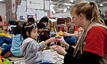Four-year-old Didi plays with Save the Children staff member Sarah Thompson in the child-friendly shelter space set up at the Atlantic City Convention Center. Four-year-old Didi plays with Save the Children staff member Sarah Thompson in the child-friendly shelter space set up at the Atlantic City Convention Center.