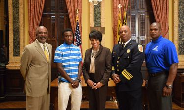 Philip Ellison, second from left, stands alongside Baltimore City officials as he is recognized for his heroic efforts. Philip Ellison, second from left, stands alongside Baltimore City officials as he is recognized for his heroic efforts.