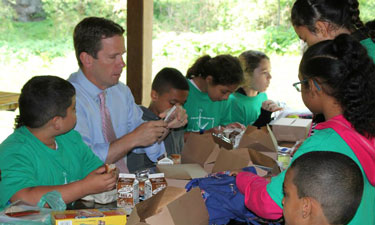 Rep. Bob Dold (R-IL-10) has lunch with children at Waukegan Park District during  a 2015 Park Champion event to check out its Summer Food Service Program.  Rep. Bob Dold (R-IL-10) has lunch with children at Waukegan Park District during  a 2015 Park Champion event to check out its Summer Food Service Program.
