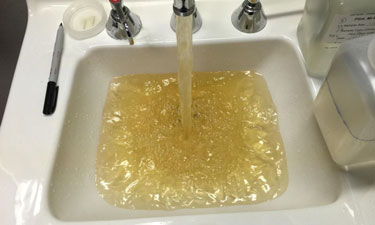 Contaminated water flows from a faucet at a Flint Hospital in October of 2015. Contaminated water flows from a faucet at a Flint Hospital in October of 2015.